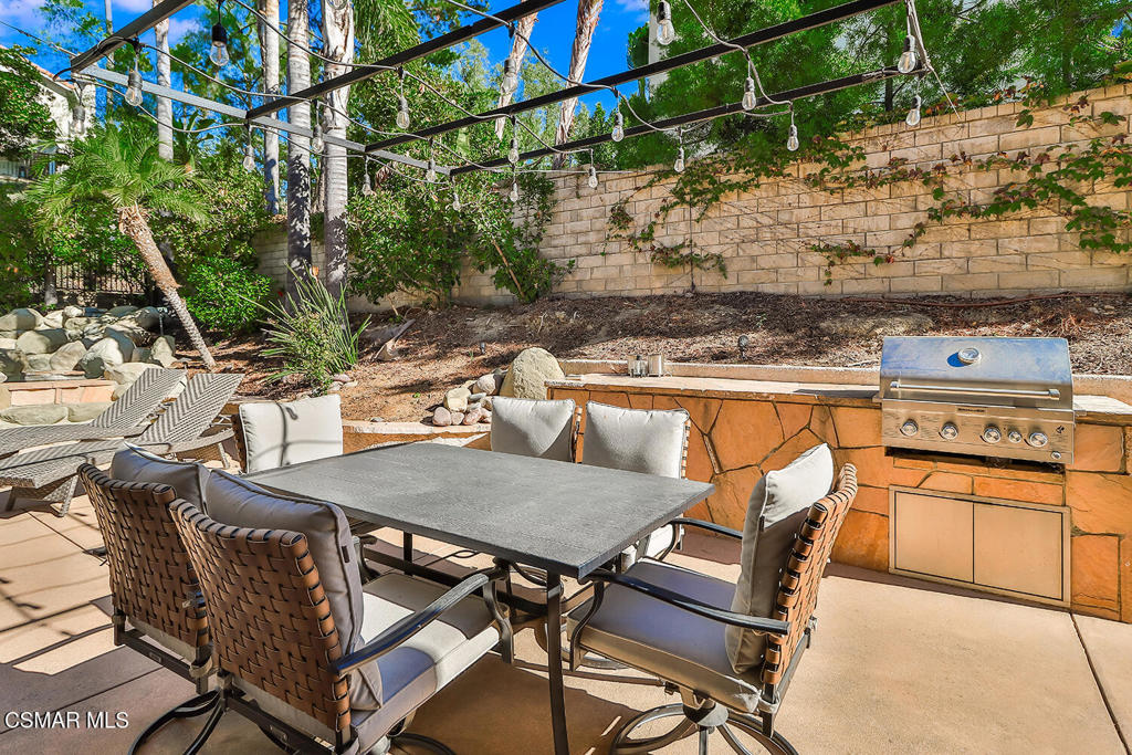 6291 Deerbrook Road Oak Park, CA 91377 - Photo 27 of 29 a view of a patio with table and chairs