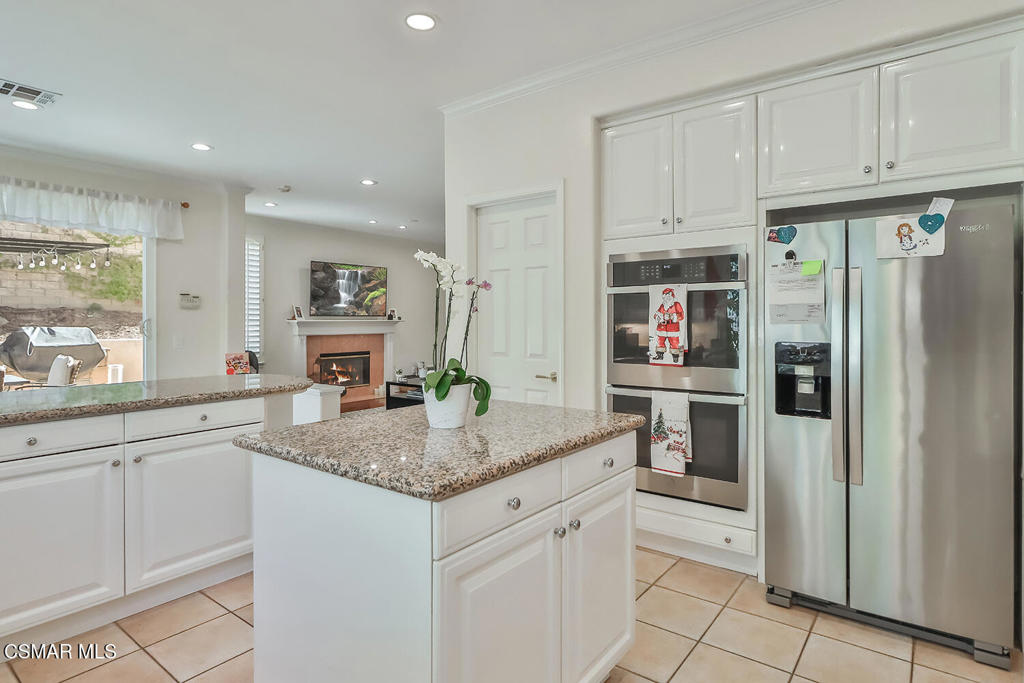 6291 Deerbrook Road Oak Park, CA 91377 - Photo 9 of 29 a kitchen with stainless steel appliances granite countertop a refrigerator and cabinets