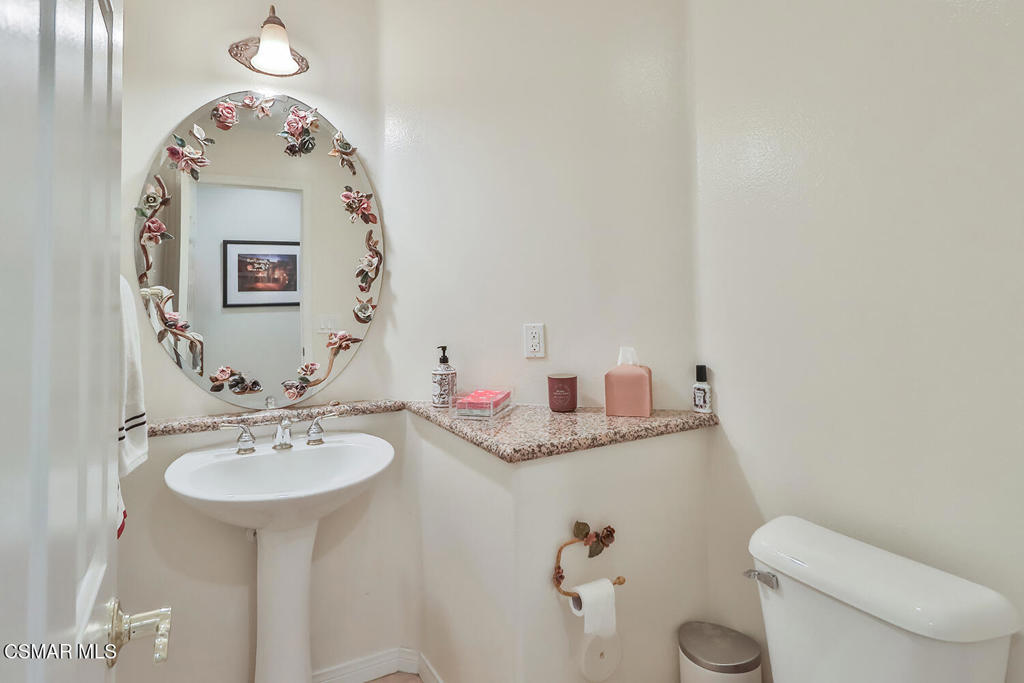 6291 Deerbrook Road Oak Park, CA 91377 - Photo 10 of 29 a bathroom with a granite countertop sink and a mirror
