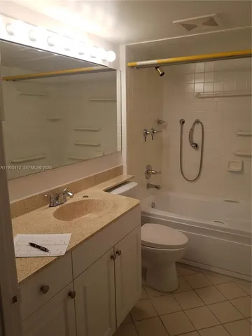 a bathroom with a granite countertop toilet a sink and a bathtub