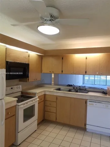 a kitchen with a sink cabinets and stainless steel appliances