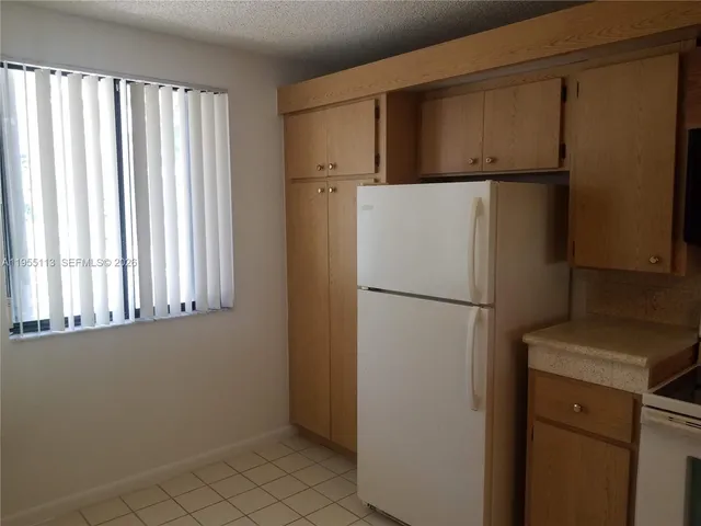 a white refrigerator freezer sitting in a kitchen