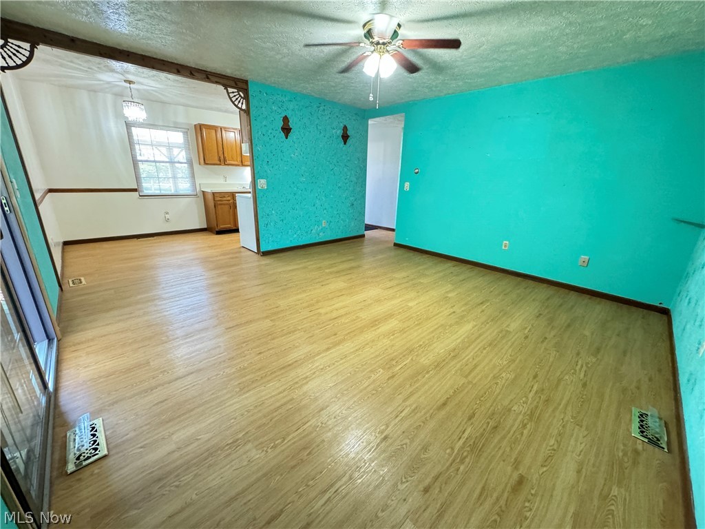 1763 Aberdeen Road Madison, OH 44057 - Photo 3 of 31 Living room featuring ceiling fan, sliding glass door to sunroom and hardwood / wood-style floors