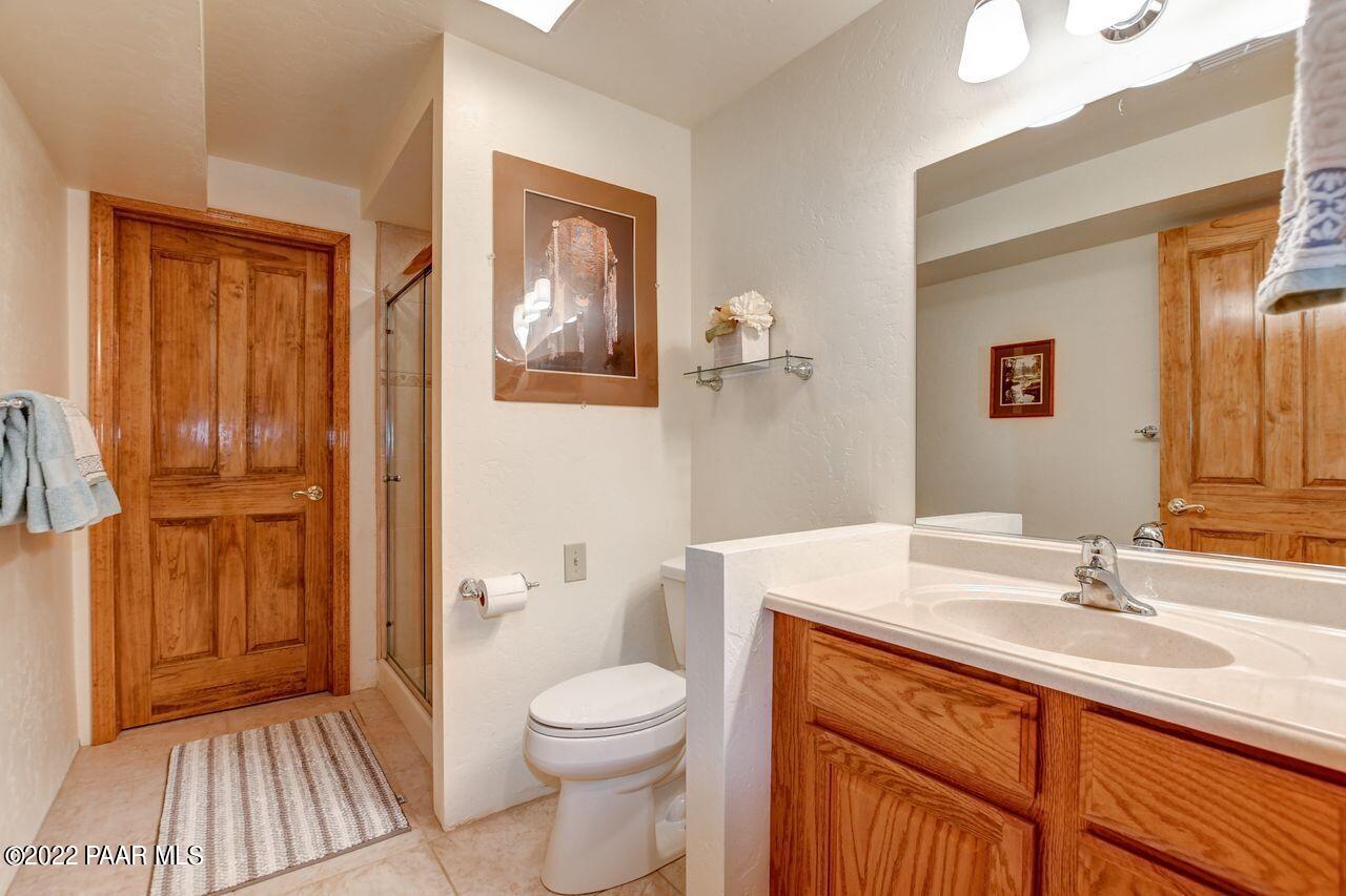 1219 Timber Point North Prescott, AZ 86303 - Photo 26 of 33 a bathroom with a sink a toilet and shower