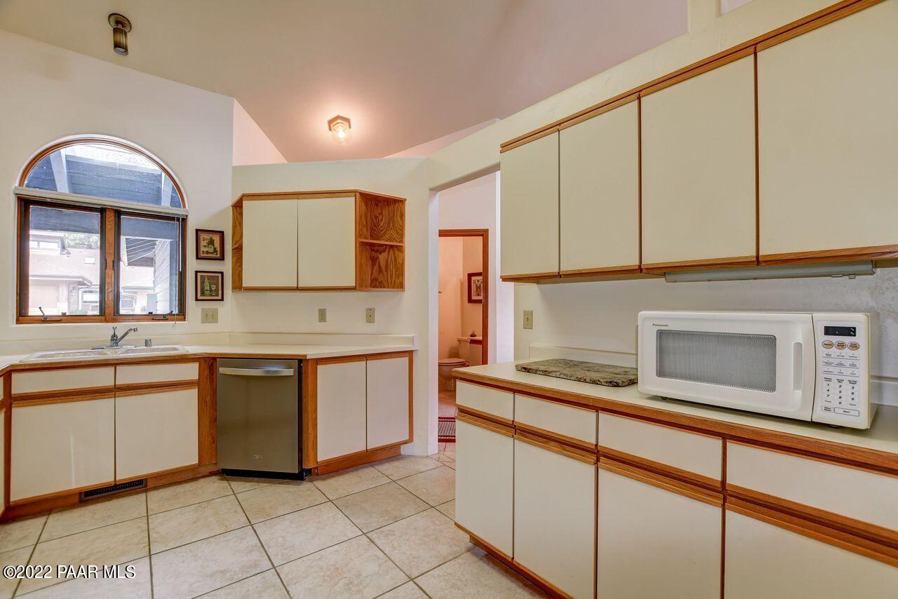 1219 Timber Point North Prescott, AZ 86303 - Photo 8 of 33 a kitchen with stainless steel appliances granite countertop a sink and cabinets