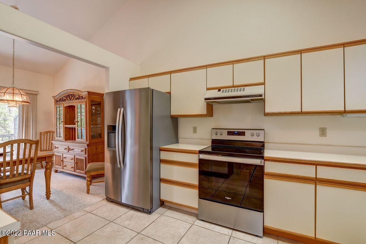 1219 Timber Point North Prescott, AZ 86303 - Photo 9 of 33 a kitchen with stainless steel appliances granite countertop a refrigerator and a stove top oven