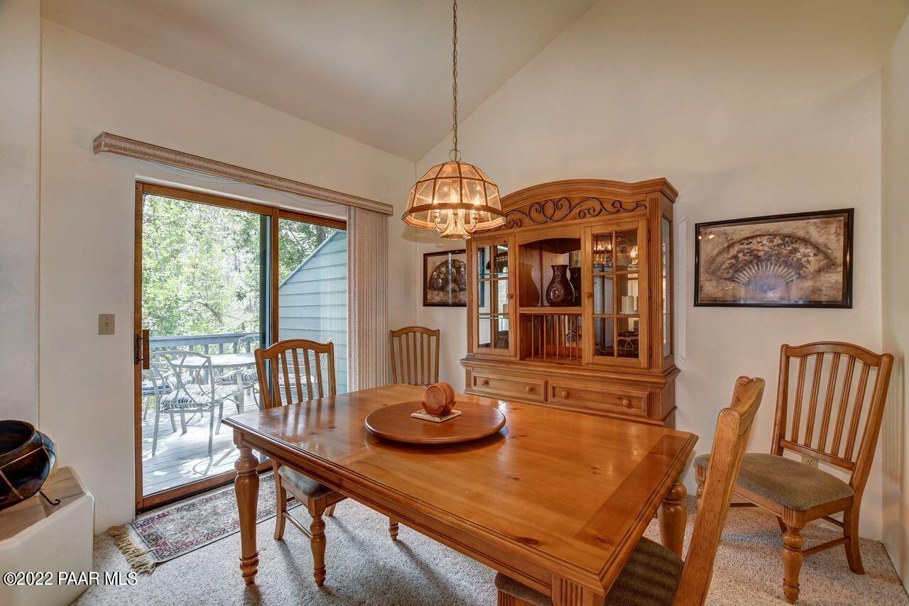 1219 Timber Point North Prescott, AZ 86303 - Photo 10 of 33 a dining room with furniture a window and a chandelier