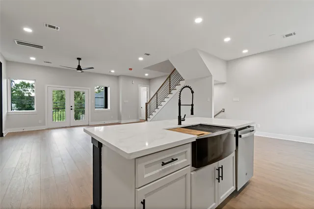 a kitchen with sink stove and cabinets