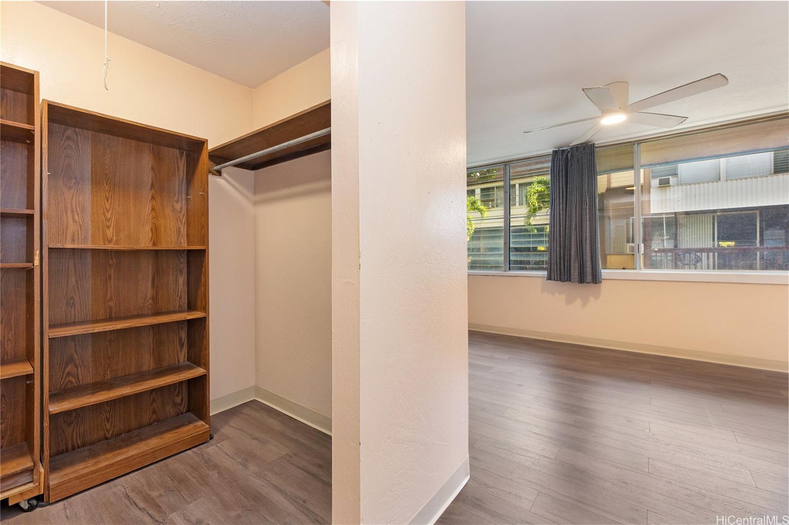 98-360 Koauka Loop, Unit 243 Aiea, HI 96701 - Photo 16 of 25 a view of an empty room with wooden floor and a window