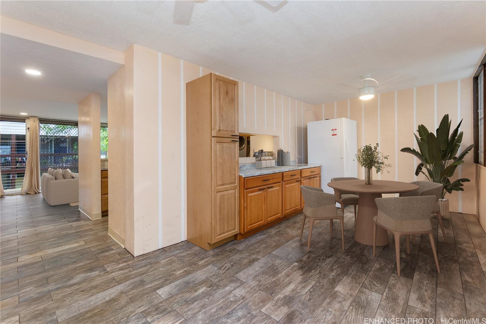 98-360 Koauka Loop, Unit 243 Aiea, HI 96701 - Photo 2 of 25 a kitchen with a table and chairs in it