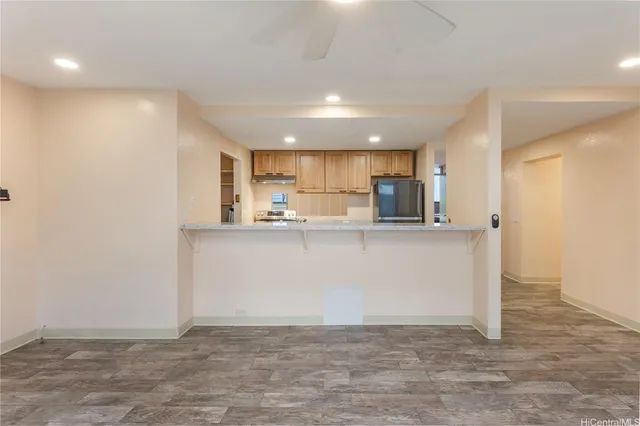 a view of kitchen with kitchen island and stainless steel appliances