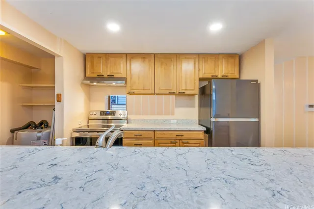 a kitchen with stainless steel appliances granite countertop a refrigerator and a sink