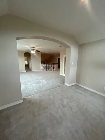 a view of a livingroom with furniture and staircase