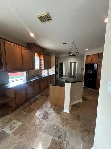 a view of a room with a ceiling fan and chandelier fan