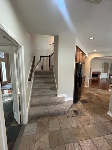 a kitchen with stainless steel appliances granite countertop a refrigerator and a stove
