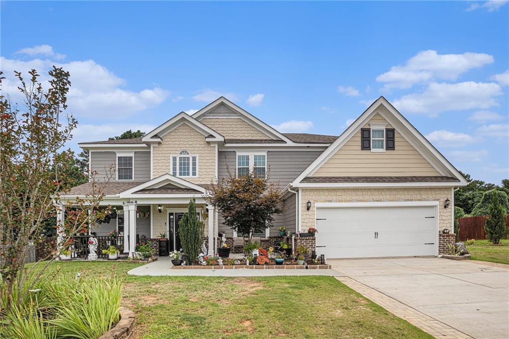 1076 Sutherland Drive Winder, GA 30680 - Photo 1 of 1 a front view of a house with a yard