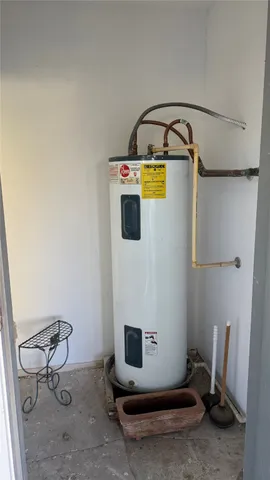 a view of a house with a yard and potted plants