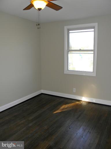 3960 S Street Southeast Washington, DC 20020 - Photo 11 of 27 an empty room with wooden floor and windows