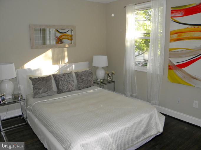 3960 S Street Southeast Washington, DC 20020 - Photo 14 of 27 a large bed sitting in a bedroom next to a window