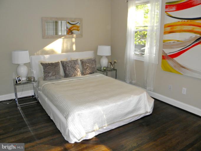 3960 S Street Southeast Washington, DC 20020 - Photo 15 of 27 a large bed sitting in a bedroom next to a window