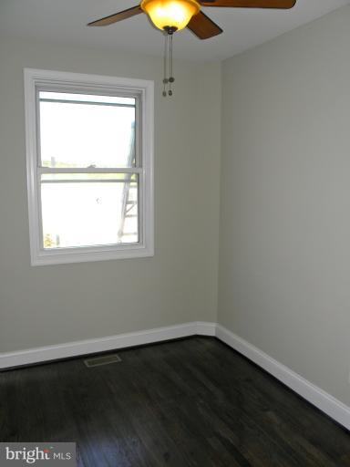 3960 S Street Southeast Washington, DC 20020 - Photo 16 of 27 a view of an empty room with wooden floor and a window