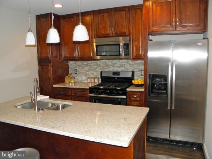 3960 S Street Southeast Washington, DC 20020 - Photo 19 of 27 a kitchen with cabinets and stainless steel appliances