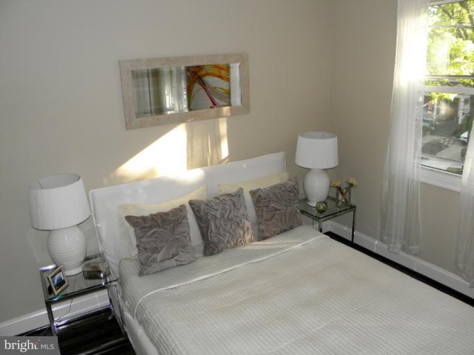 3960 S Street Southeast Washington, DC 20020 - Photo 25 of 27 a bedroom with a bed and a lamp on table