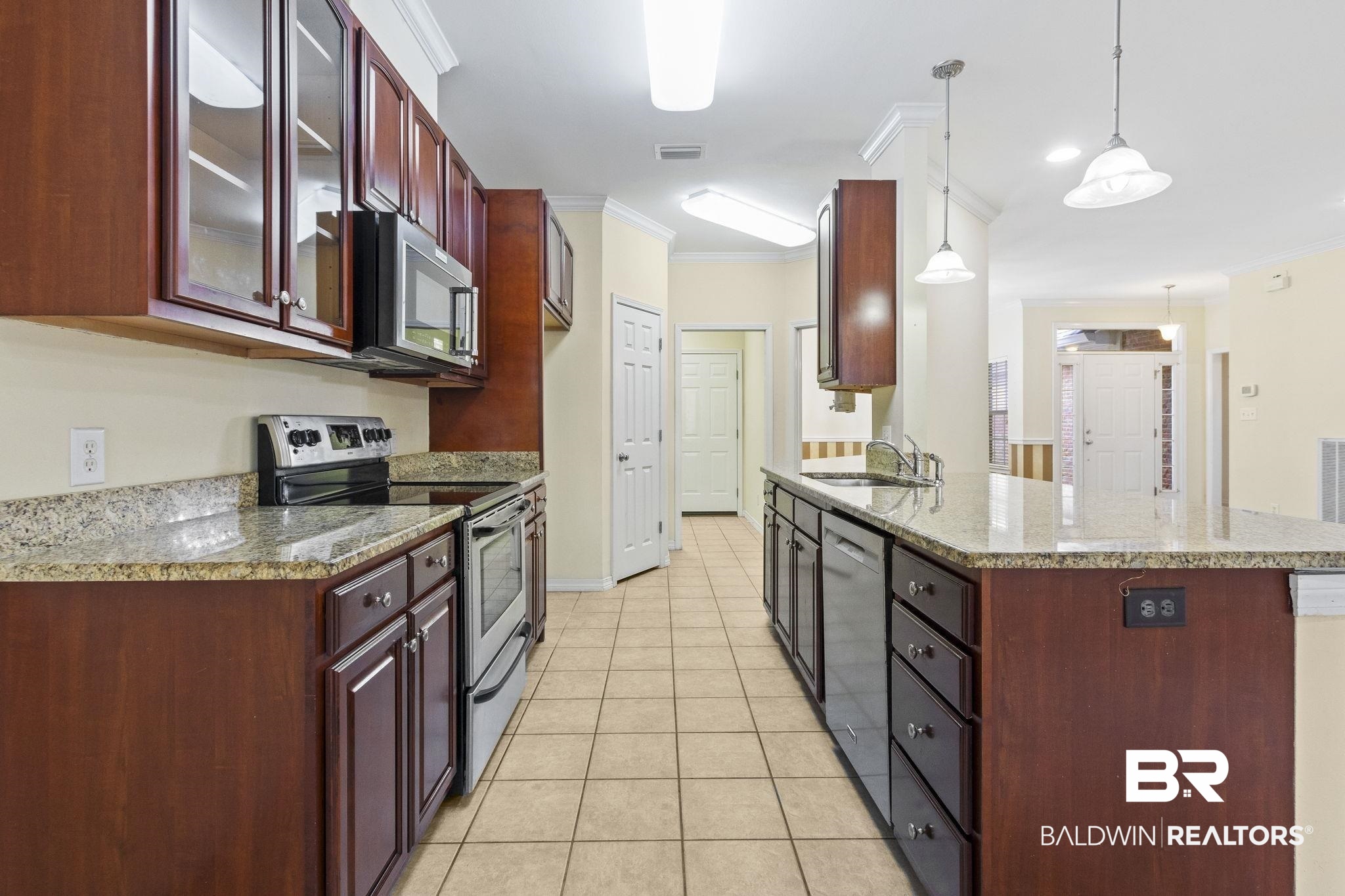 166 Club Drive Fairhope, AL 36532 - Photo 12 of 41 Kitchen with ornamental molding, light tile patterned floors, stainless steel appliances, sink, and hanging light fixtures