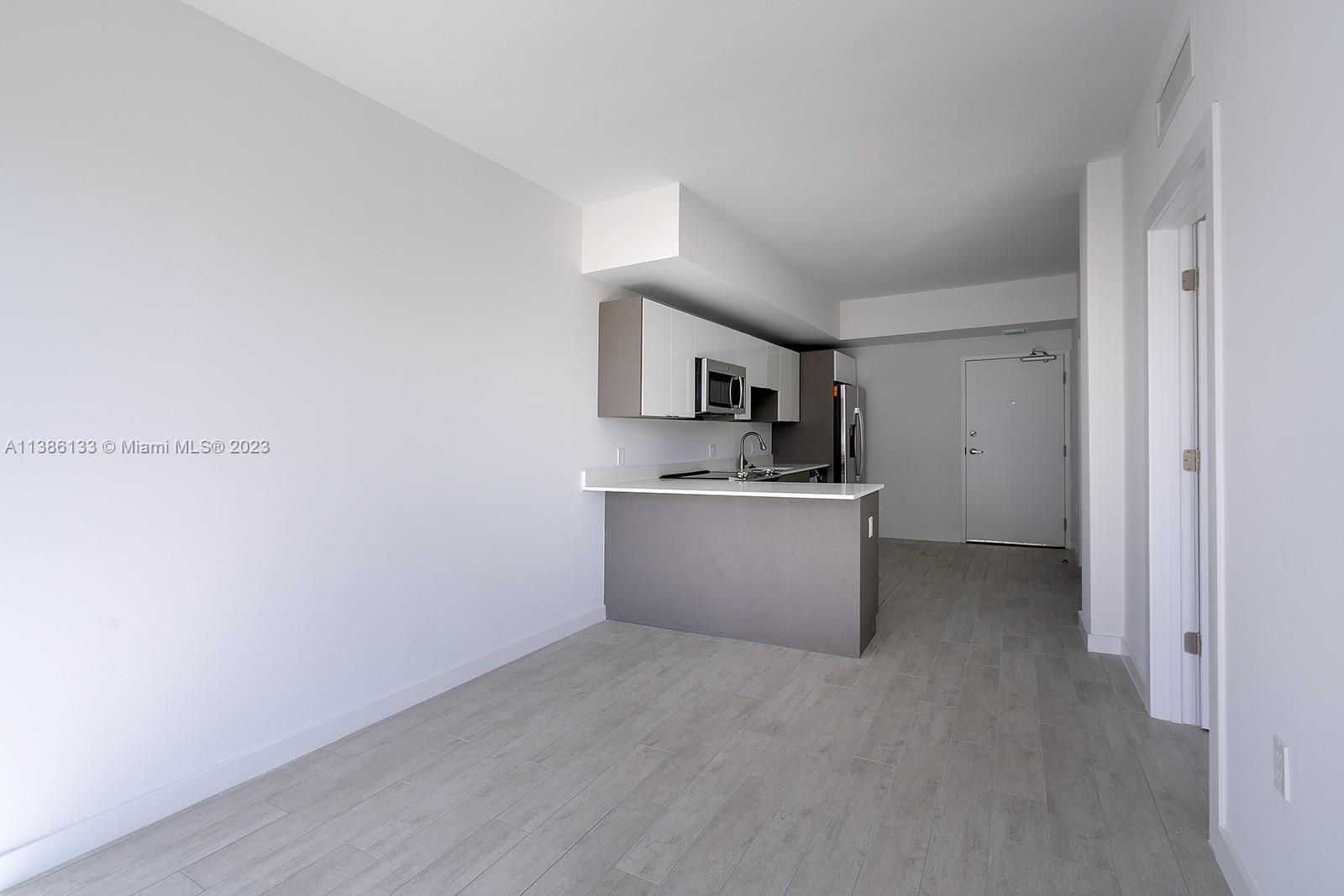 321 Northeast 26th Street, Unit 615 Miami, FL 33137 - Photo 7 of 15 a view of a kitchen with a sink and dishwasher