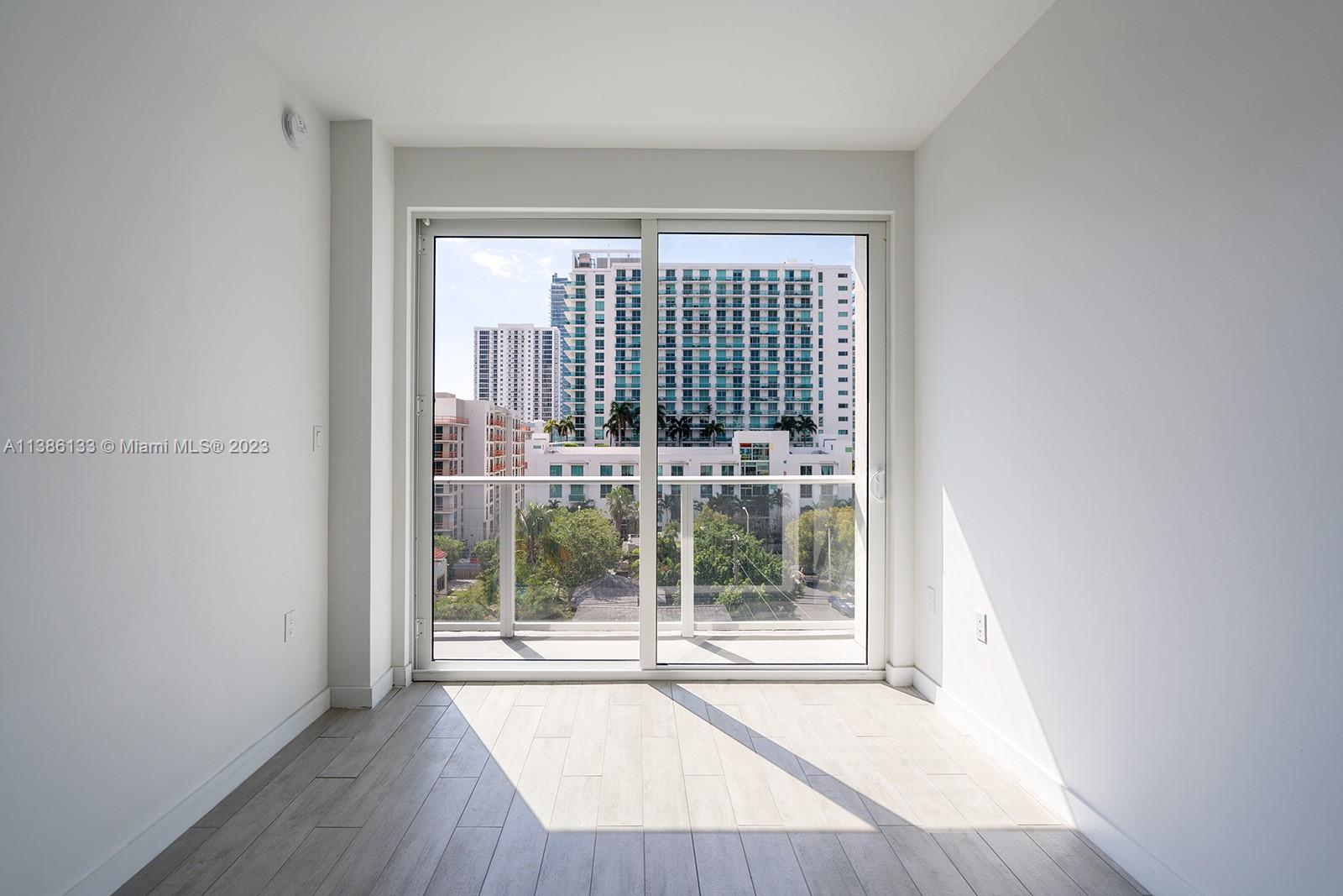 321 Northeast 26th Street, Unit 615 Miami, FL 33137 - Photo 8 of 15 a view of a room with wooden floor and a window