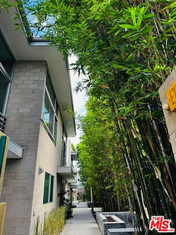 a bedroom with a bed and glass door