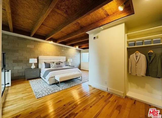 a view of a white house with a table and chairs in patio