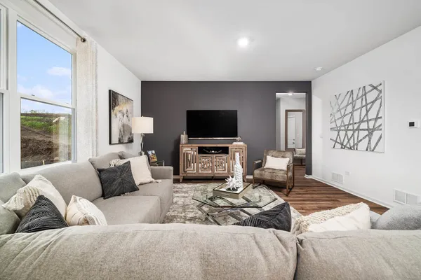 a living room with furniture and a flat screen tv