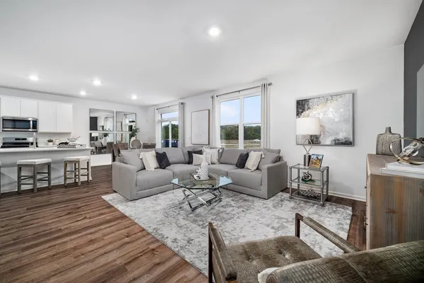 a living room with furniture and wooden floor