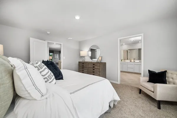a large bedroom with a bed and a couch