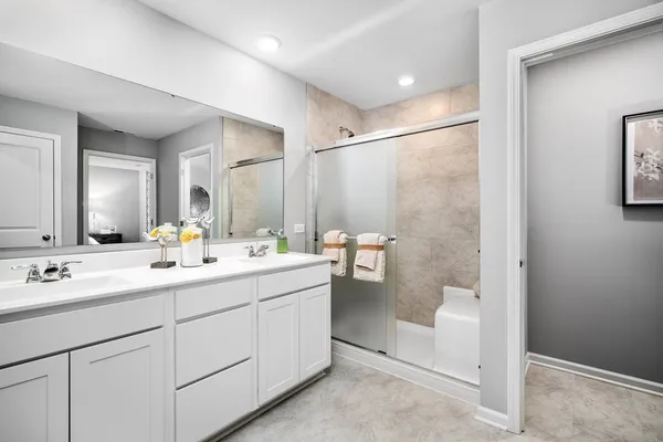 a bathroom with a double vanity sink mirror and toilet