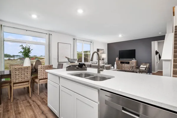 a kitchen with a sink cabinets and wooden floor