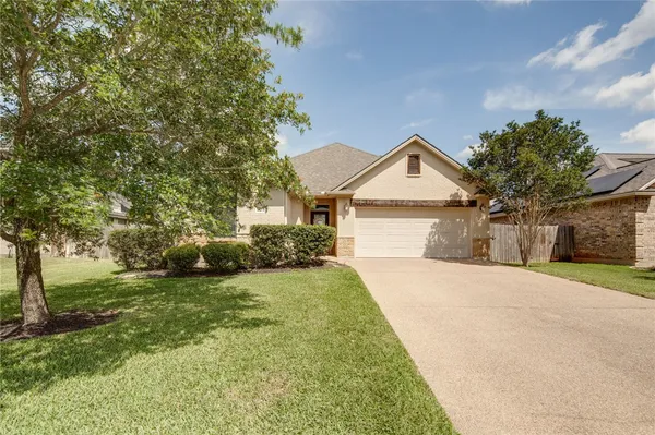 a front view of a house with a yard garage and outdoor seating