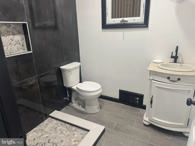 a bathroom with a toilet and a sink