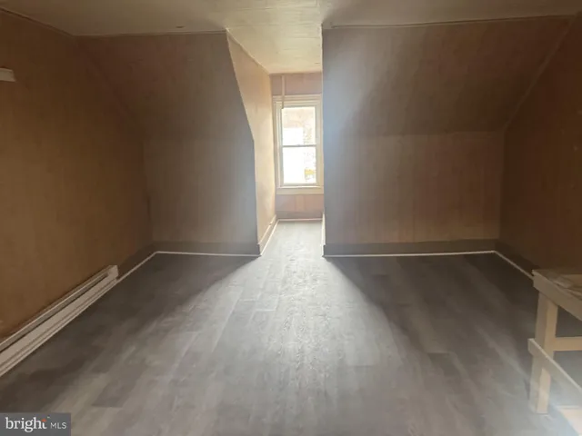 a view of a room with wooden floor and window