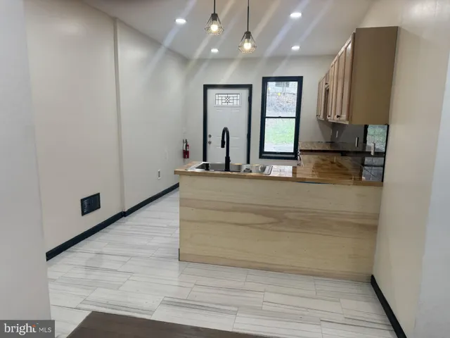 a view of a hallway with wooden floor and entryway