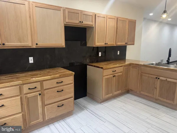 a kitchen with appliances cabinets and a sink