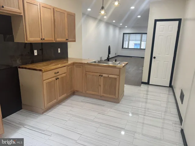 a kitchen with stainless steel appliances granite countertop a sink and a stove