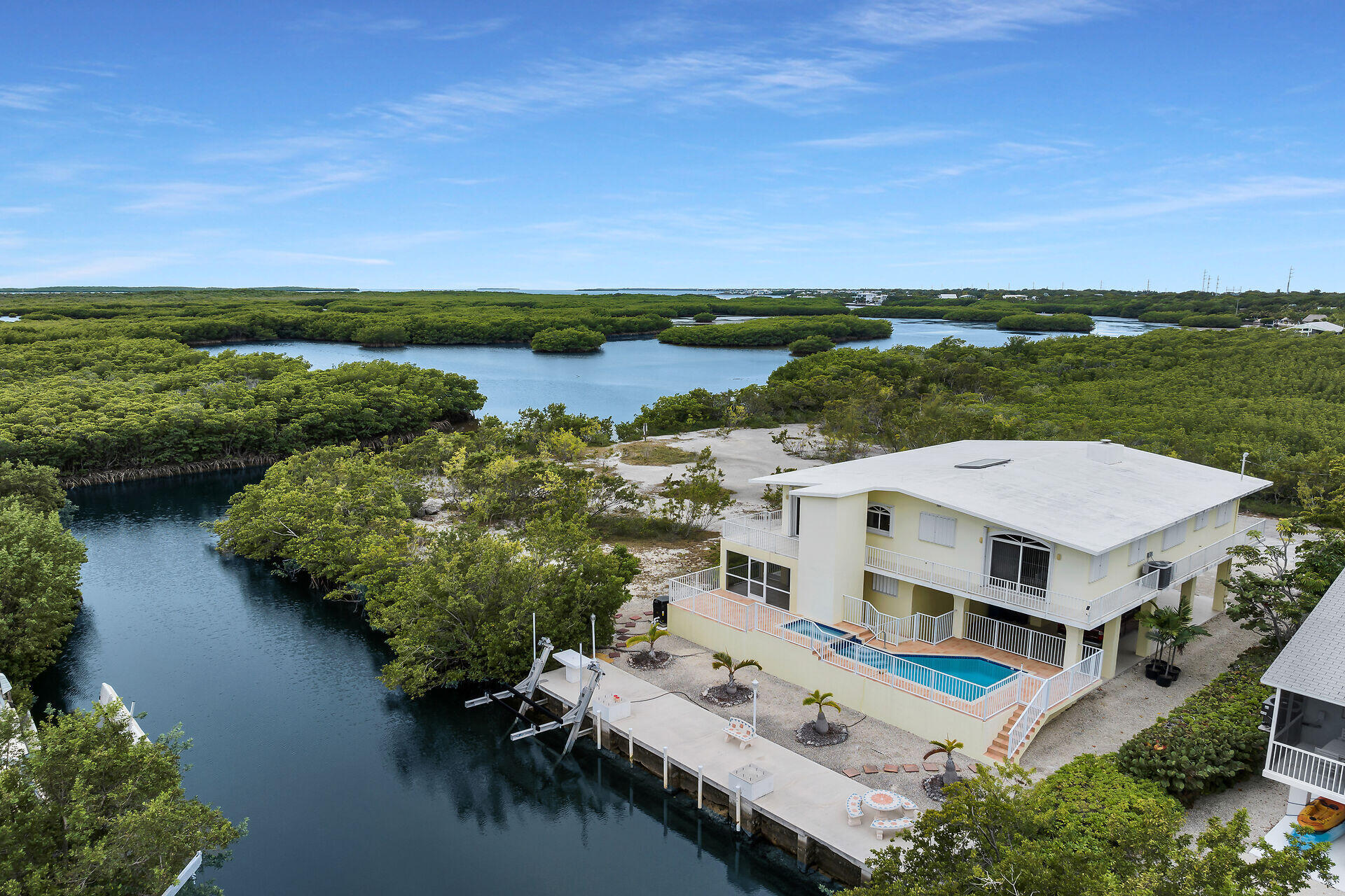 an aerial view of residential houses with outdoor space and seating
