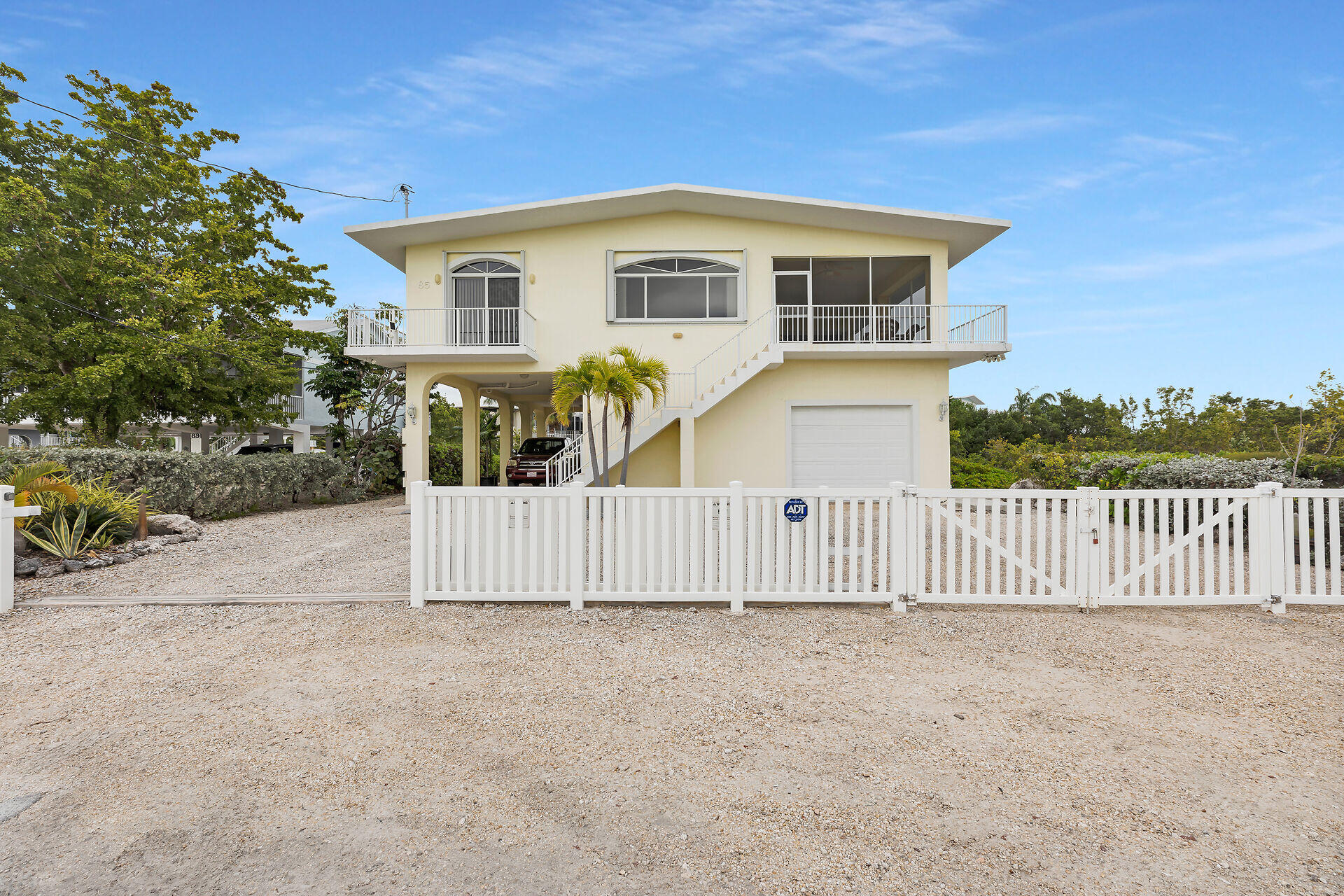 85 Ocean Shores Drive Key Largo, FL 33037 - Photo 16 of 77 a front view of a house with a fence