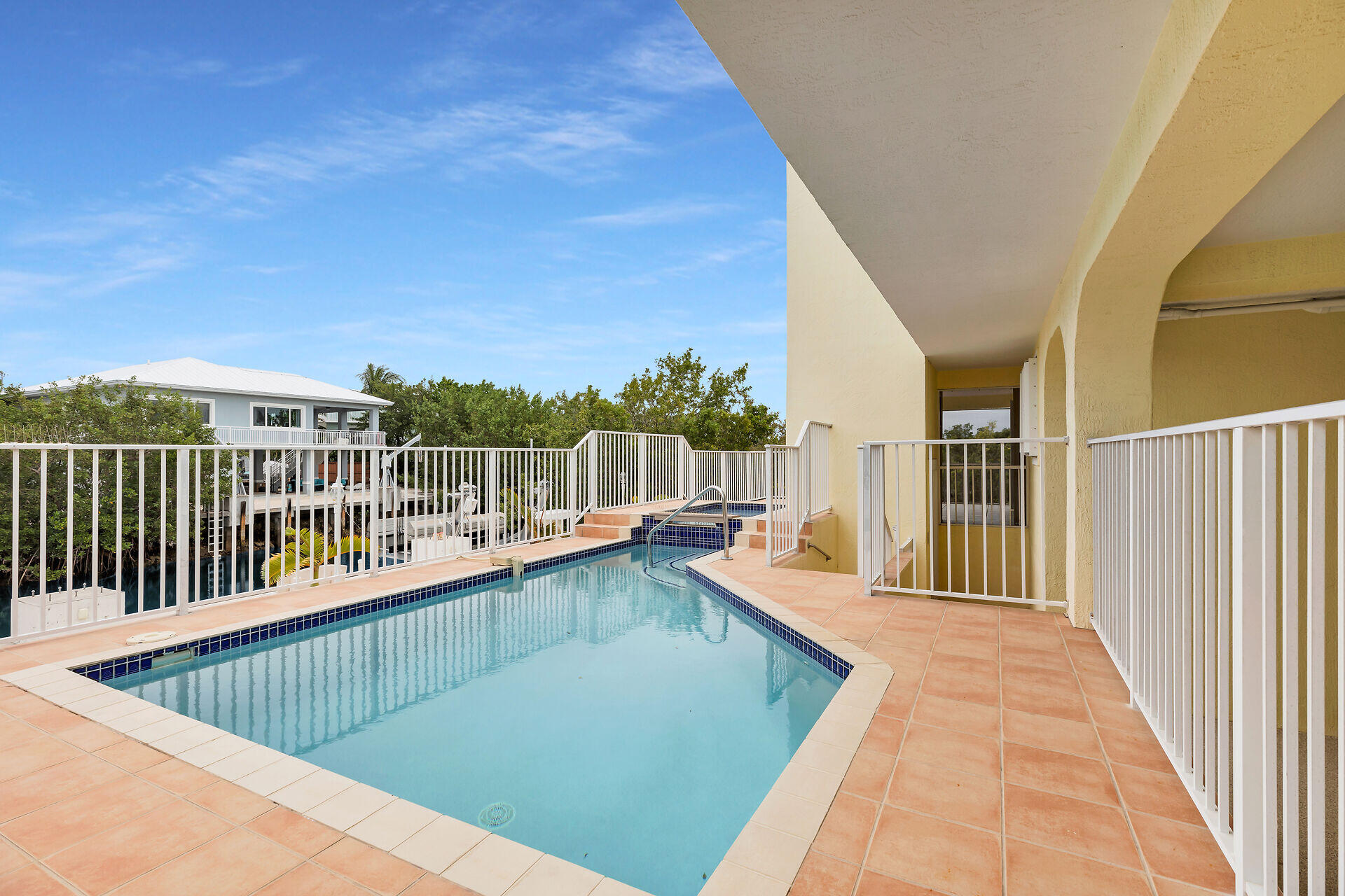 85 Ocean Shores Drive Key Largo, FL 33037 - Photo 20 of 77 a view of a balcony with wooden floor and fence