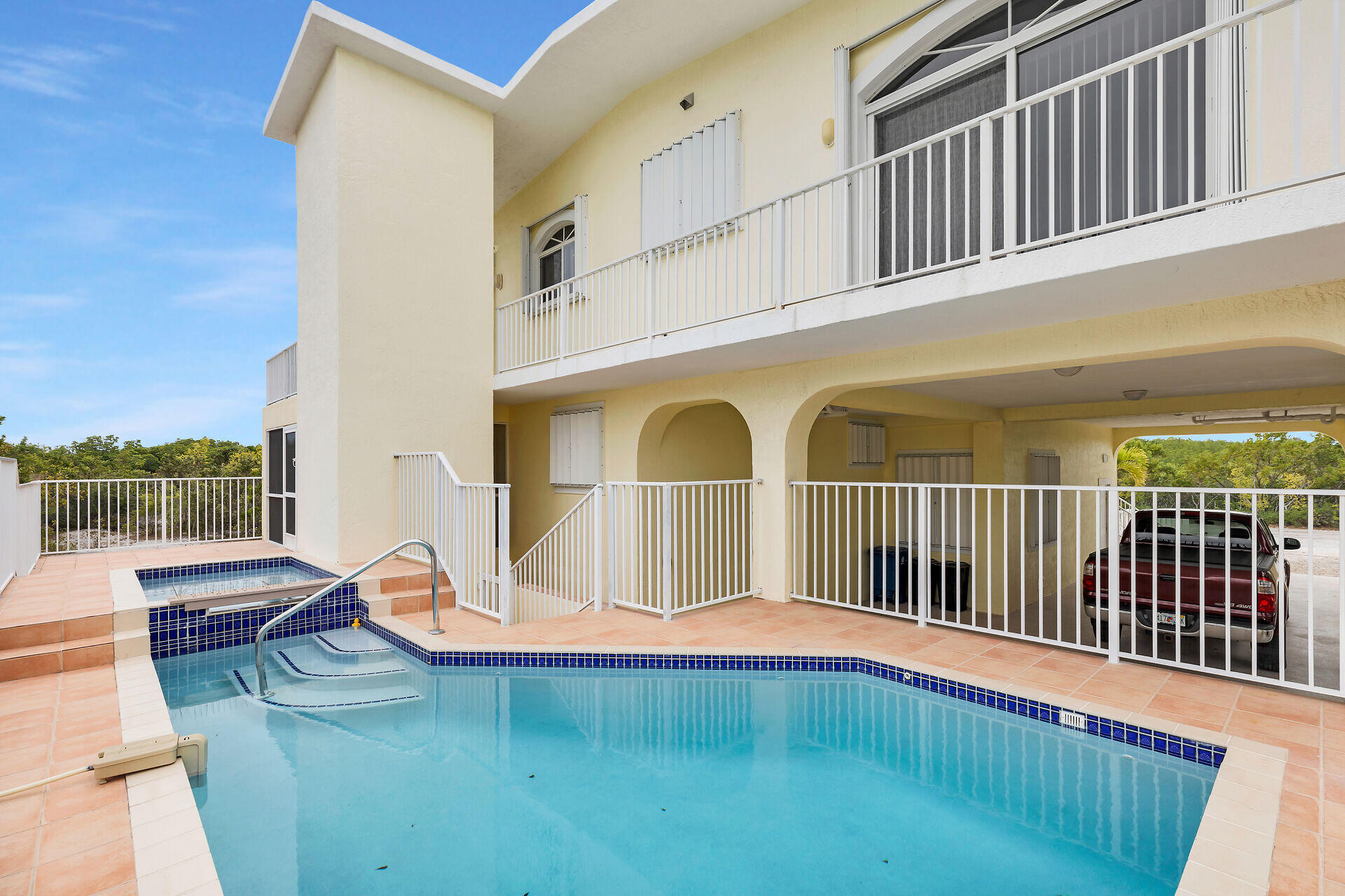 85 Ocean Shores Drive Key Largo, FL 33037 - Photo 2 of 77 a view of a swimming pool with a lounge chair