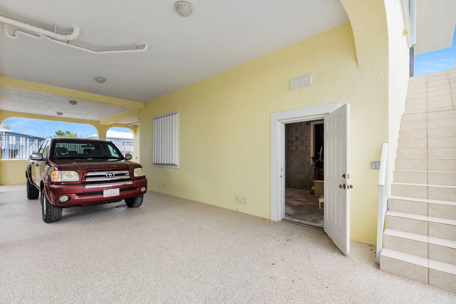 85 Ocean Shores Drive Key Largo, FL 33037 - Photo 27 of 77 a car parked in front of a yellow building