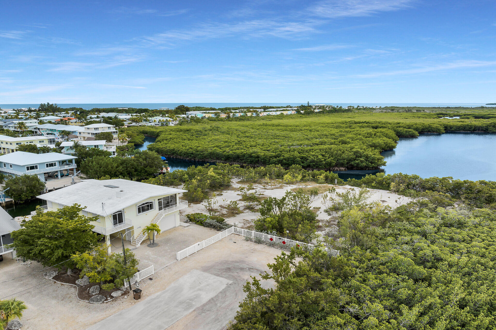 85 Ocean Shores Drive Key Largo, FL 33037 - Photo 3 of 77 a view of a lake with houses in the back