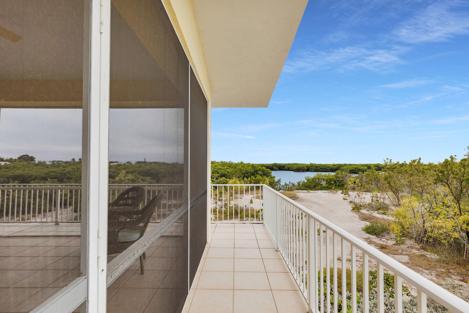 85 Ocean Shores Drive Key Largo, FL 33037 - Photo 31 of 77 a view of a balcony with floor to ceiling windows with wooden floor
